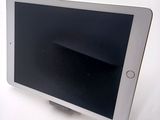 a tablet computer sitting on top of a white table