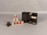 a small camera and several jars of spices on the table
