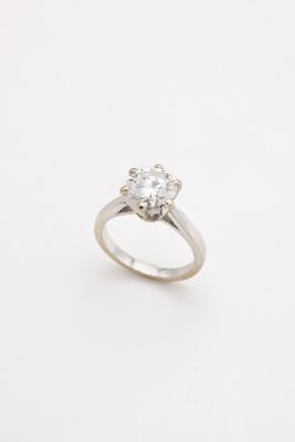 a close up of a diamond ring on a white background