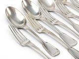 six spoons and six spoons on a white surface