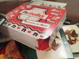 a box of cookies sitting on top of a pile of other boxes