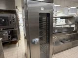 stainless steel ovens in a commercial kitchen with a tiled floor