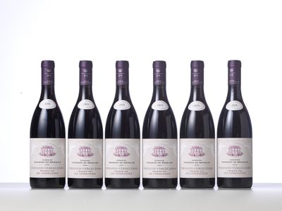 six bottles of wine are lined up on a table