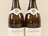 two bottles of wine sitting next to each other on top of a table
