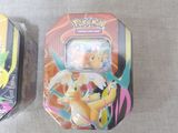 two pokemon tins that are sitting on a table