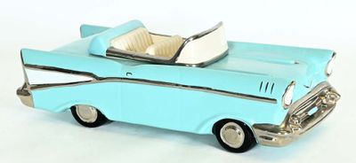 a blue toy car that is sitting on a white surface
