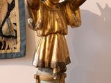 a statue of a woman holding her hands up in the air