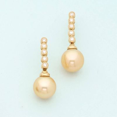 a pair of pearl and diamond earrings