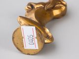 pair of gold - plated figurines of a man and a woman holding hands