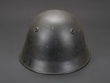 an old steel helmet with holes on the side of it