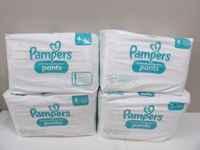 three packs of pampers pants sitting on top of each other