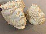 pair of white marble busts of men with hats and beards