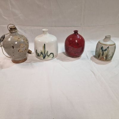 several different types of vases sitting on a white surface