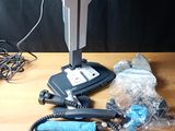 a vacuum that is sitting on a table next to other items