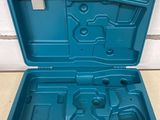 a blue tool box with tools in it sitting on the floor