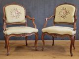 pair of antique chairs with floral upholstered upholstered cushions
