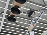 three lights that are hanging from the ceiling of a building
