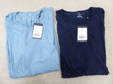 two men ' s t - shirts with tags on them sitting next to each other