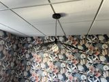 a bed in a room with a floral wallpaper on the wall