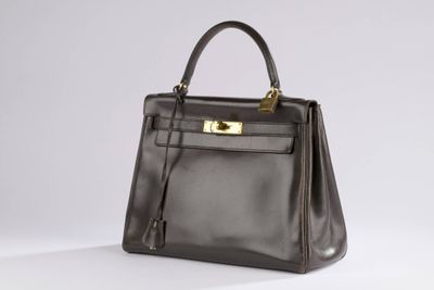 a brown leather handbag on a white background