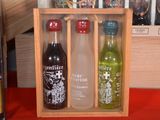 three bottles of alcohol in a wooden box