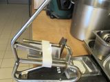 a metal sink and a metal pot on a counter