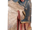 an old statue of a man sitting on a chair with his head in his hands