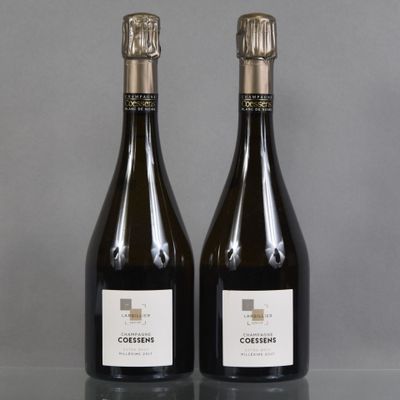 two bottles of wine sitting on top of a table next to each other