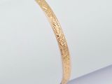 a close up of a gold bracelet on a napkin