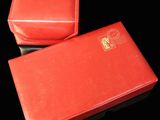 two red boxes that are sitting on a black surface