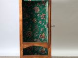 an image of a wooden cabinet with a green floral pattern on it