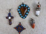 several different pieces of jewelry sitting on top of a white surface