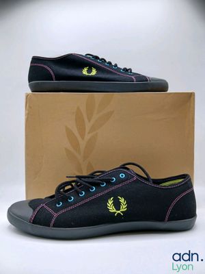 black sneakers with a green and yellow logo on the side