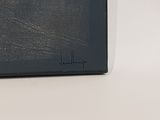 an image of a black leather wallet on a white surface