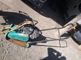 a lawn mower that is laying on the ground