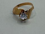 a picture of a gold ring with a diamond on it