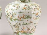 pair of chinese vases with animals and flowers on them