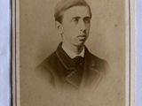 an old photo of a man in a suit and bow tie