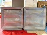 two silver cabinets sitting next to each other on a red carpet