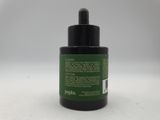 a bottle of black ink sitting on top of a white surface
