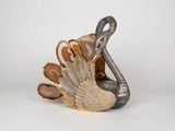 a figurine of a bird that is sitting on a table