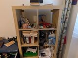 a book shelf in the corner of a living room