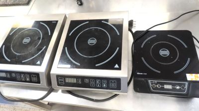three black and white burners sitting on top of a counter top