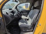 a yellow truck with two seats in the back of it