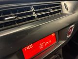 a close up of a car ' s dashboard with a clock on it
