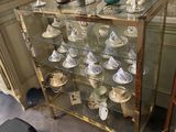 a glass display case with a lot of dishes on it