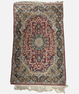 a red and blue rug with a medallion design on a white background