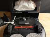 a robot that is sitting on the floor next to a trash can