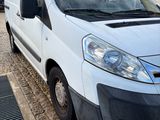 the white van is parked on the side of the road