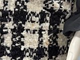 a close up of a black and white jacket with a black and white checkered pattern